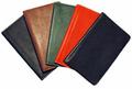 black, tan, red and greed leather tally books