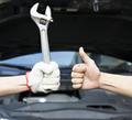 A hand holding a wrench