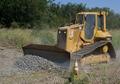 Caterpillar D5N dozer levels out the ground along the track on this vegetation control project.
