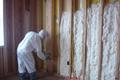A worker installing Icynene spray foam insulation.