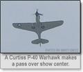 :: A Curtiss P-40 Warhawk makes a pass over show center ::