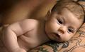 Father with tattoo on arm holding baby