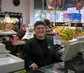 Image of mentally disabled female working at a cash register.